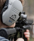 Person wearing Razor Digital XTRM Bluetooth Hunting Earmuffs With Sound Enhancing Tech Electronic Hearing Protection Gel Earpads