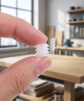Holding a white plastic dowel insert close-up, Plastic Dowel Inserts And Mounting Screws For Hinges Kit - M4x8mm White Dowels For Cabinet Doors