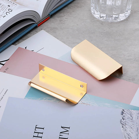 10 Pack Brushed Gold Edge Finger Cabinet Pulls 3.15 Inch Aluminum Drawer Handles on a desk with books and papers