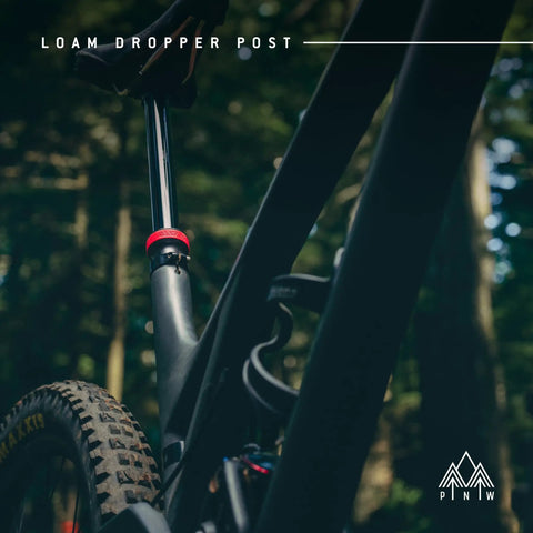 Side view of Loam Dropper Post Gen 2 Black Internal Routing MTB Seatpost With 25mm Adjustable Travel in mountain setting