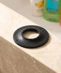 10pcs Rubber Bathtub Plug Gasket for Pop-up Stopper Drain Seal on wet marble surface, showing rubber washer design.