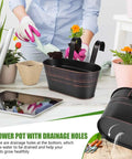 4 Pack Black Metal Hanging Flower Pots To Level Up Railing Decor Iron Planters With Drain Holes, shown during planting.