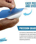 Hands peeling a PSA lapping film sheet showing easy peel and stick feature, Aluminum Oxide AO for Scary Sharp sharpening system.