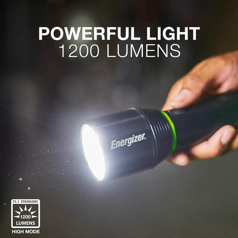 Person holding black Vision HD Rechargeable LED Flashlight With Digital Focus, Water Resistant Emergency Light in a dark room.