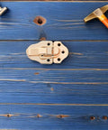 Six Golden Metal Toggle Latches For Vintage Wood Boxes Tool Cases And Suitcases on blue wooden surface with hammer.