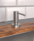 Talis Modern Bath And Kitchen Sink Soap Dispenser In Stainless Steel Optic on wooden counter near tile backsplash