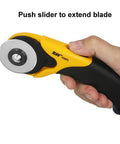 Hand holding 45mm Rotary Cutter And Precision Knife Set For Art Quilting And Crafting With ergonomic aluminum handle and anti-slip grip.