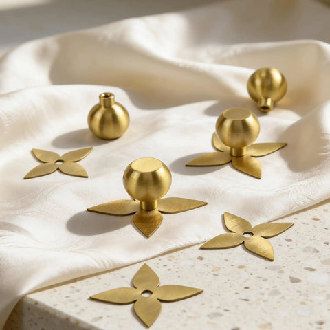 Solid Brass Gold Cabinet Knobs 4 Pack With Star Backplates on fabric, brushed brass finish, shown uninstalled for kitchen cupboard and dresser.