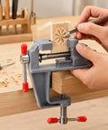 Zero Drama Mini Bench Vise Sturdy Table Mount Badass High Carbon Steel Adjustable Clamp For DIY Models Jewelry Woodworking And Precision Hobbies With Grips That Lock Down Fast holding a carved wood piece.