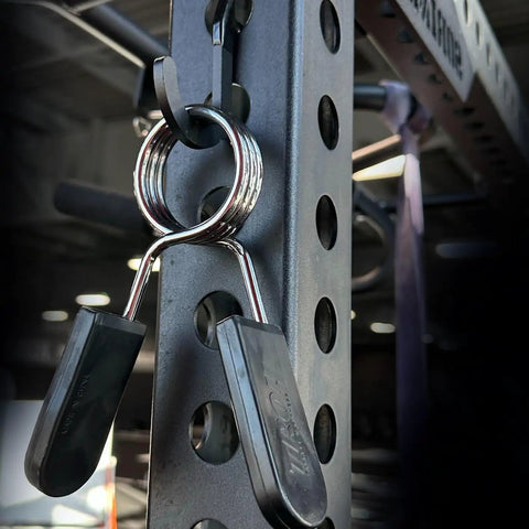 Close-up of Squat Rack Hooks And Power Rack Attachments For DIY Storage with barbell collars on 1 inch hole-spaced rack (Black).