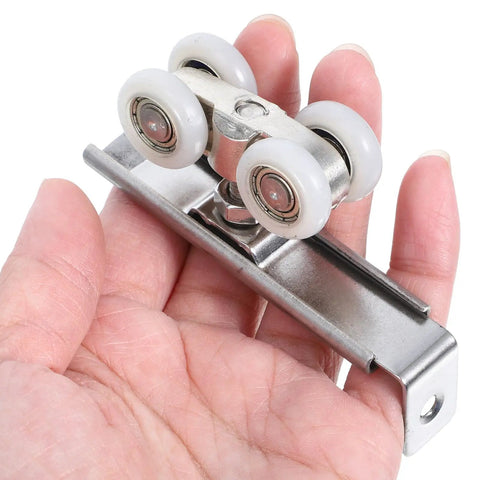 Top Notch Two Piece Stainless Steel Barn Door Roller Hardware With Foolproof Wall Mounted Track And Heavy Duty Wheels For Tight Rooms And Hassle Free Install, showcasing durable roller wheels in hand.