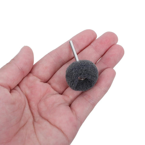 100Pcs Abrasive Buffing Wheels Rotary Tool Polishing Accessories 1.8 Inch showing a gray buffing wheel held in a hand.