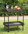 Wicker Patio Serving Cart With All Weather Resin Wicker And Durable Steel Frame Espresso Finish The Go To Outdoor Entertaining Cart With Two Storage Shelves For Deck Or Backyard Parties shown in a grassy outdoor setting with drinks and fruit on top shelf.