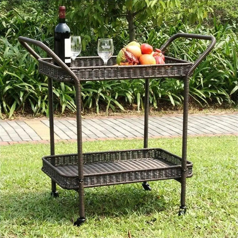 Wicker Patio Serving Cart With All Weather Resin Wicker And Durable Steel Frame Espresso Finish The Go To Outdoor Entertaining Cart With Two Storage Shelves For Deck Or Backyard Parties shown in a grassy outdoor setting with drinks and fruit on top shelf.