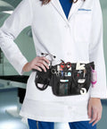 Nurse wearing a Nurse Fanny Pack With Tape Holder And Multi Pocket Medical Gear Organizer Belt Bag For Stethoscopes Bandage Scissors And Medical Supplies Durable Water Resistant Waist Apron Style For Nurses in a clinical setting.