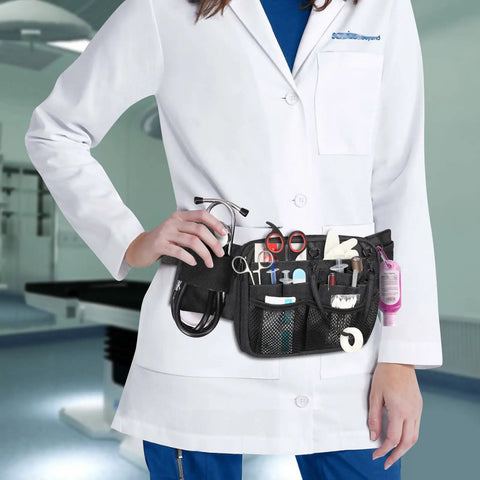 Nurse wearing a Nurse Fanny Pack With Tape Holder And Multi Pocket Medical Gear Organizer Belt Bag For Stethoscopes Bandage Scissors And Medical Supplies Durable Water Resistant Waist Apron Style For Nurses in a clinical setting.