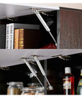 Heavy Duty Pneumatic Gas Struts Hydraulic Cabinet Door Lift Knockout Kitchen Prop Holder installed on sleek wood cabinet.