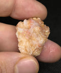 Hand holding Spencer Idaho Pink Opal Rough Cutting Material Dope Multicolor Loose Gem 70.80 Cts ideal for jewelry making