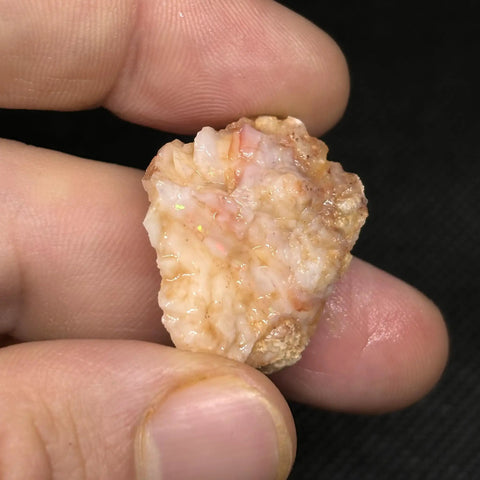 Hand holding Spencer Idaho Pink Opal Rough Cutting Material Dope Multicolor Loose Gem 70.80 Cts ideal for jewelry making