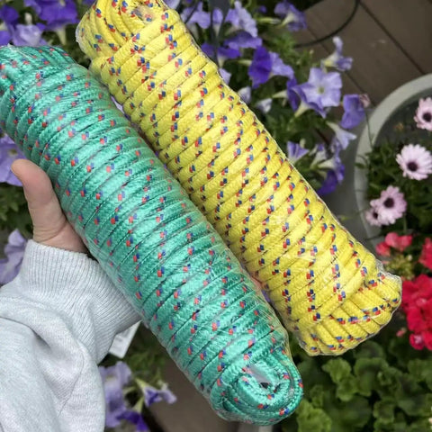 Two rolls of multicolor yellow and green polypropylene rope held in hand; part of 4 Pack 50 Feet Each Three Eighths Inch Polypropylene Rope Heavy Duty All Purpose Utility Line Weather Resistant Tie Downs For Camping, Fishing, Pulling And Outdoor Use Multicolor Red Yellow Blue Green.