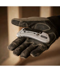 Gloved hand holding Sport Knife With Easy Blade Change And One Handed Quick Slide Blade Slider Takes Standard Utility Blades Silver Finish
