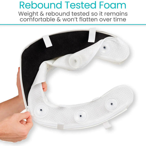 Person holding Toilet Seat Cushion Soft Foam Donut Pad For Elongated And Standard Seats with suction cups visible.