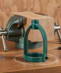 Upgrade Your Woodworking With This Heavy Duty Mortising Machine Drill Press Attachment next to a wood clamp and block.