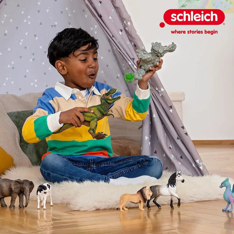 Child playing with dinosaur and horse figures on wooden floor beside a play tent, surrounded by animal toys.