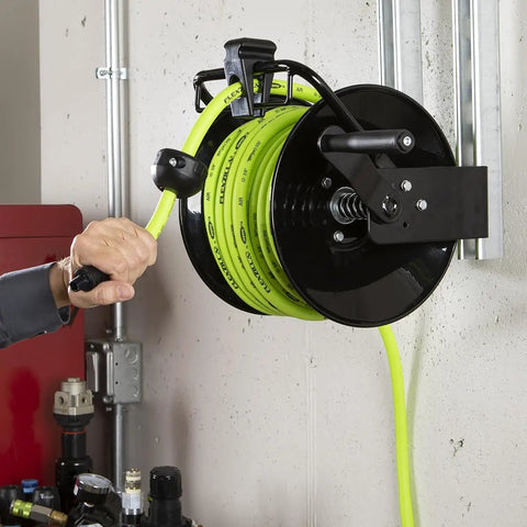 Manual Open Face Air Hose Reel 1/4 Inch By 100 Feet Hybrid ZillaGreen mounted on wall, showing hose layering guide in use