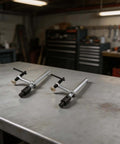 Two Pack Beefy Metal Hold Down Clamps For Woodworking 16mm Dog Hole Bench Clips With Ergonomic Handle on workshop table