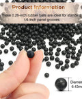 Raised Panel Cabinet Door Spacers 500 Pack Quarter Inch Black Rubber Ball Bumpers shown being held with other balls in background.