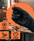 Thick 8 Mil Black Nitrile Gloves Heavy Duty Disposable Work Gear With Serious Diamond Grip Touchscreen Ready Oil Water Resistant All Day Flex Pack Of 100 Large Size holding a dripping oily screw.