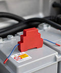 Auto Aerosol Fire Extinguishers With Dual Nozzles For Slick Hands Off Flame Control on battery with red device.