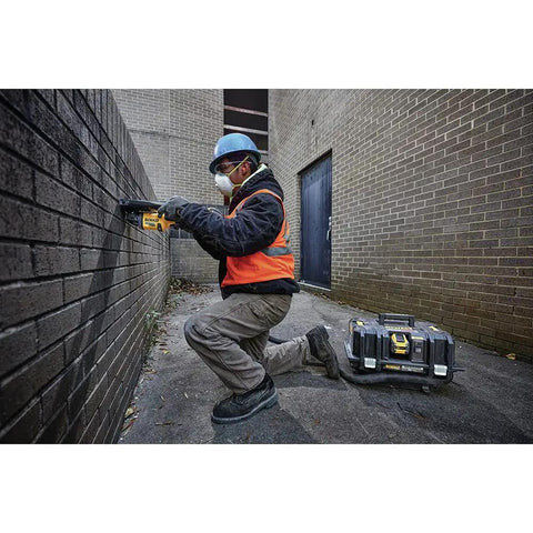 Worker using FlexVolt 60V Max Cordless Angle Grinder With Kickback Brake for brickwork, tool only, 9000 RPM, outdoor construction site