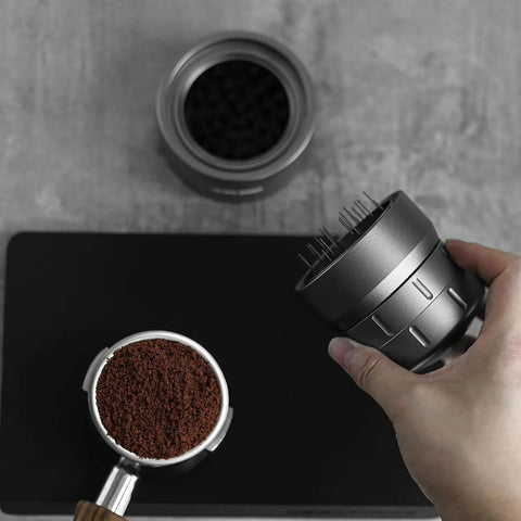 58mm Espresso Coffee Distributor Tool For Even Dosing With 22 Needle Layout Adjustable Depth Grey Pro Barista Gear For Professional Espresso Machines Today shown above a portafilter with coffee grounds.