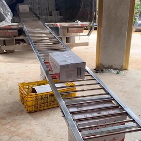 Heavy Duty Galvanized Steel Roller Conveyor For Warehouse Freight And Logistics Unloading with boxes moving down ramp.
