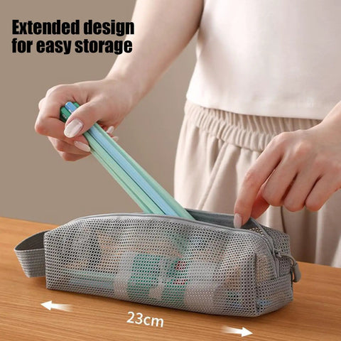 Travel Toiletry Bag With Ventilated Mesh Storage Ultra Portable Road Trip Ready in gray being opened on a table.