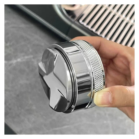 Close-up of Prime Pick 58Mm Espresso Coffee Distributor And Adjustable Palm Tamper, stainless steel with cushioned grip, held in hand.