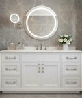 Bathroom vanity with white cabinets, silver handles, round mirrors, and marble countertop.