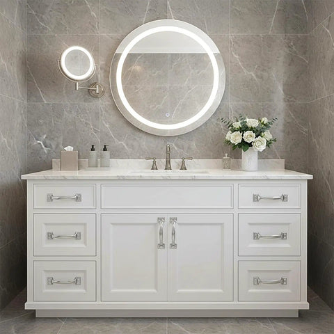 Bathroom vanity with white cabinets, silver handles, round mirrors, and marble countertop.