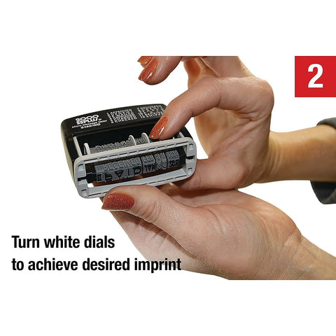 Close-up of hands adjusting white dials on Slick Self Inking Micro Message Dater Stamp With Quick Flip Phrases for precise imprint.