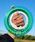 Hand holding Blue Kite String Reel With Lock, 650ft Spool, 7.2 Inch Line Winder for Easy String Management against blue sky