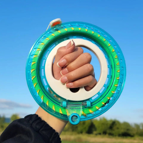 Hand holding Blue Kite String Reel With Lock, 650ft Spool, 7.2 Inch Line Winder for Easy String Management against blue sky