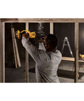 Man using a cordless stud drill for framing work, featuring Power Detect Technology, tough framing tasks.
