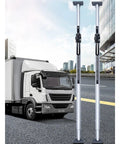 Heavy Duty Aluminum Telescopic Cargo Restraint Bar That Tightens Up Nice And Fast With Grip Pads For Secure Truck Bed Divider And Box Trailer Load Hauling next to a truck.