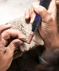 Hands using Tough As Nails Multi Speed Mini Electric Angle Grinder with sanding bit on wood for detailing crafts.