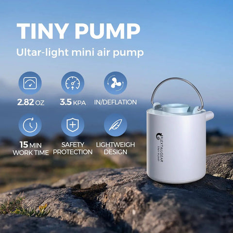 Tiny Ultra Mini Portable Air Pump For Inflatables on rock showing features like 2.82 oz size, lightweight design, inflate and deflate