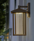 Seeded Glass Outdoor Wall Light with Dusk to Dawn Sensor, 1000 Lumens of Warm 3000K Glow, 15.5 Inch Tall Porch Lantern in bronze finish.