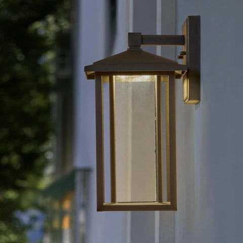 Seeded Glass Outdoor Wall Light with Dusk to Dawn Sensor, 1000 Lumens of Warm 3000K Glow, 15.5 Inch Tall Porch Lantern in bronze finish.