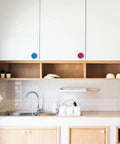 Four Piece Door Knob Molds For Epoxy Resin in kitchen, colorful polygonal knobs on white cabinets.